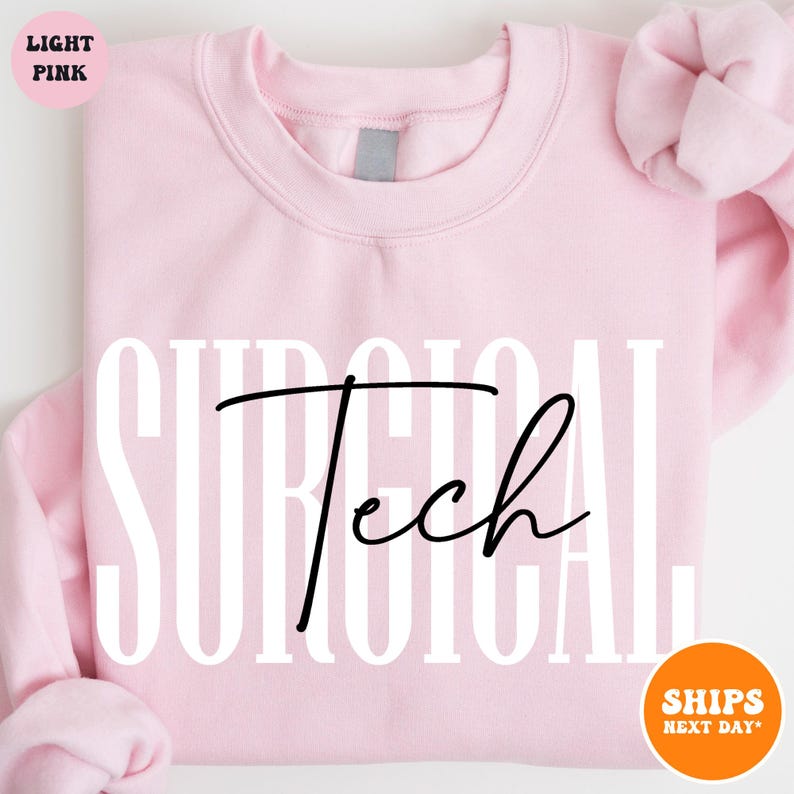 May include: Light pink sweatshirt with the text "SURGICAL Tech" in white and black lettering.