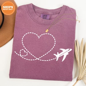 a t - shirt with a heart and a plane on it