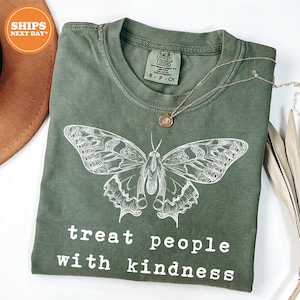 a green t - shirt with a butterfly on it
