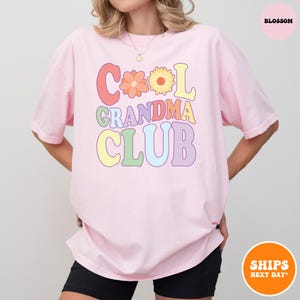 a woman wearing a pink t - shirt that says cool grandma club