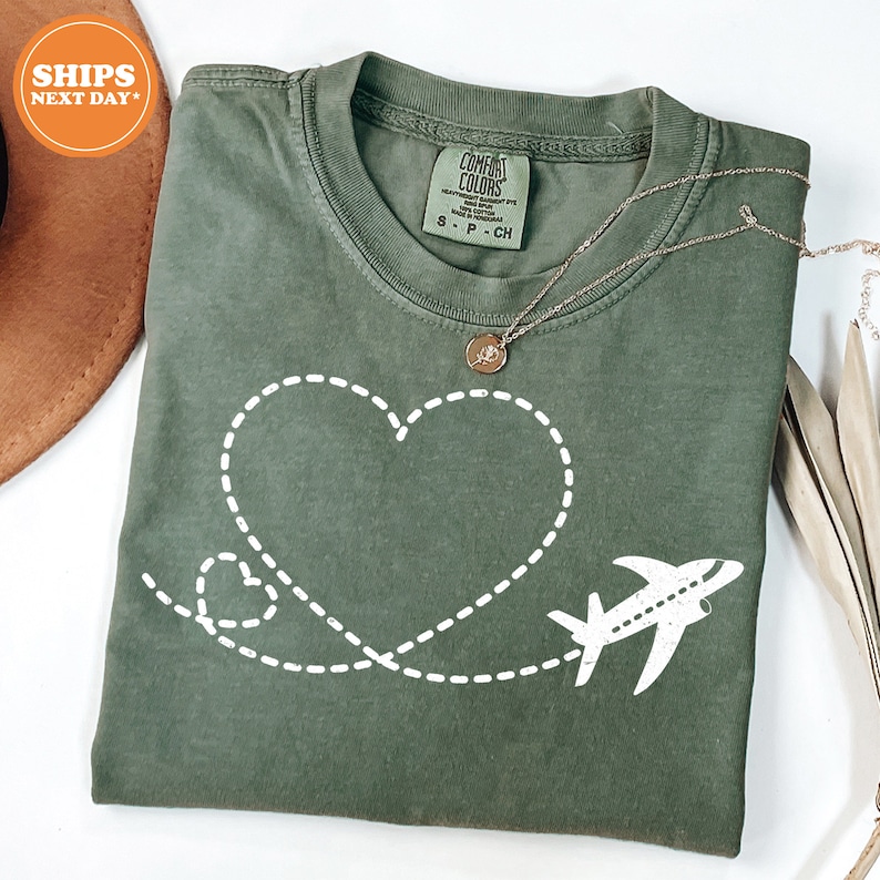 a t - shirt with a heart and a plane drawn on it