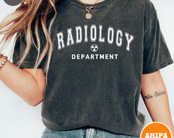May include: A dark gray t-shirt with the text "RADIOLOGY DEPARTMENT" in white with a white radiation symbol.