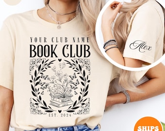 May include: Cream-colored t-shirt with a black graphic design for a book club. The design includes the text "YOUR CLUB NAME BOOK CLUB" above an illustration of books, butterflies, and flowers. The text "EST. 2024" is also included.