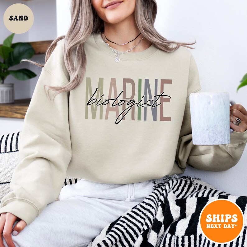 a woman sitting on a couch holding a cup of coffee