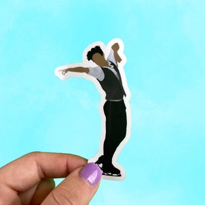 May include: A black and white sticker of a figure skater in a black vest and pants, with one arm raised and the other pointing forward. The figure skater is on a white background.
