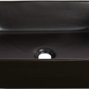 May include: A black ceramic vessel sink with a square shape and a single drain hole in the center.