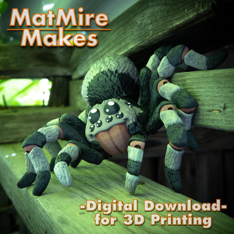 May include: A 3D printed model of a spider with large, white eyes and black and white striped legs. The spider is sitting on a wooden surface. The text "MatMire Makes - Digital Download - for 3D Printing" is visible below the spider.