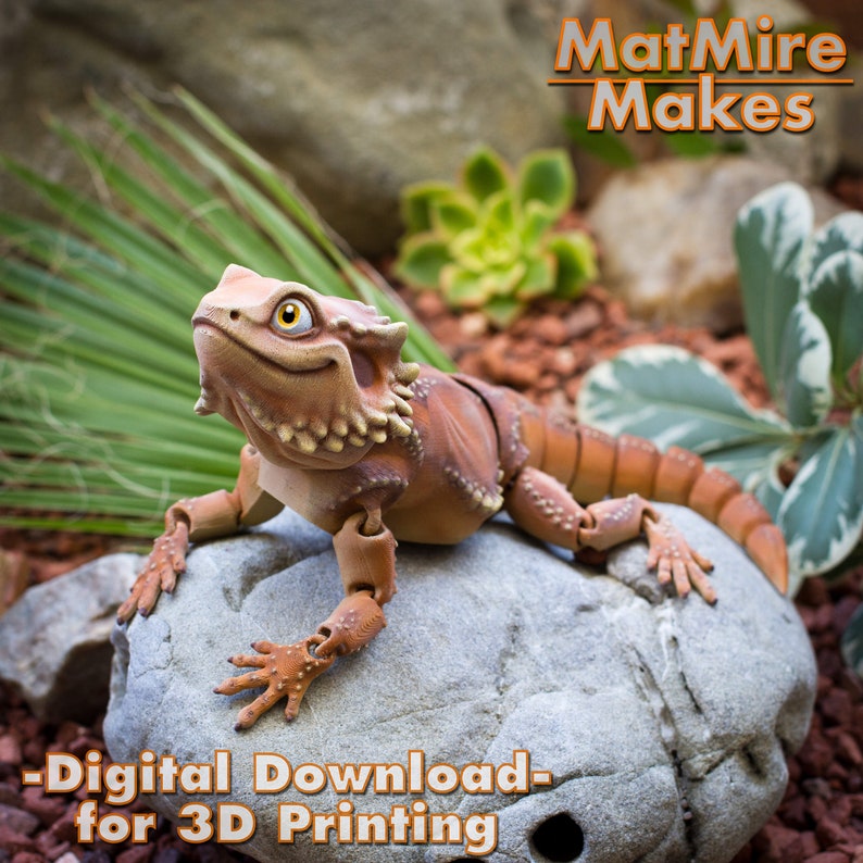 May include: A 3D printed articulated model of a bearded dragon lizard, posed on a rock. The model is brown and tan with a textured surface. The text "MatMire Makes - Digital Download - for 3D Printing" is visible below the lizard.