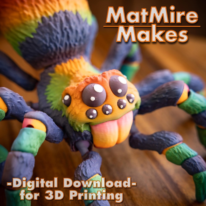 May include: A colorful 3D printed spider with a rainbow color scheme. The spider has large, expressive eyes and a playful tongue sticking out. The text "MattMire Makes - Digital Download - for 3D Printing" is visible at the top of the image.