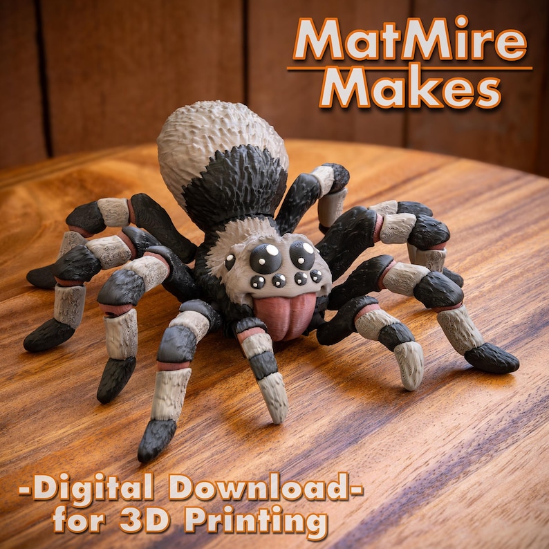 May include: A 3D printed model of a spider with black and white stripes. The spider has a large, round head with large, black eyes. The spider is posed with its legs spread out. The model is printed in a light gray color. The image includes the text "MatMire Makes - Digital Download - for 3D Printing".