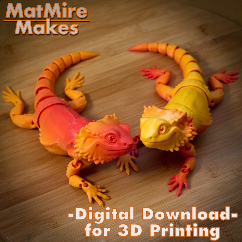 May include: Two 3D printed articulated lizard figurines, one orange and red, the other yellow, on a wooden surface. The text "MatMire Makes - Digital Download - for 3D Printing" is below the lizards.