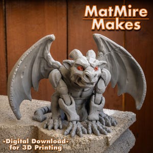 May include: A gray gargoyle figurine with red eyes, large wings, and horns. The text MatMire Makes is visible at the top, and the text Digital Download for 3D Printing is visible at the bottom. The figure has a textured, stone-like appearance.