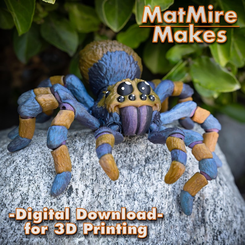 May include: A blue and yellow 3D printed spider model with segmented legs and a purple mouth. The spider is sitting on a gray rock. -Digital Download- for 3D Printing. MatMire Makes.