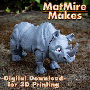 Puede incluir: Figura de rinoceronte gris impresa en 3D con un diseño de dibujos animados. El rinoceronte tiene un cuerno grande, orejas pequeñas y ojos rojos. El texto "MatMire Makes" y "-Digital Download- for 3D Printing" se muestra en naranja y blanco.