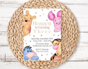 May include: A Winnie the Pooh themed birthday party invitation with a white background and colorful confetti. The invitation features Winnie the Pooh, Piglet, Tigger, and Eeyore. The text reads "Bennett is turning Three, Saturday November 12th, From 1:00 - 3:00 PM, 110 Sunset Drive, Fredericton NB E3C 1E5, RSVP Michelle, WWW WWW WWWW".