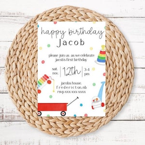 May include: A white birthday invitation with colorful illustrations of toys, including a red wagon, a toy xylophone, a stacking toy, and a toy vacuum. The text reads "happy birthday Jacob, please join us as we celebrate Jacob's first birthday, sat. nov. 12th 3-4 pm, jacobs house. fredericton. nb rsvp xxx-xxx-xxxx".