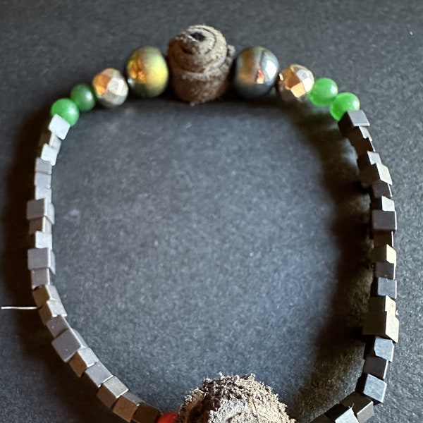 A unique boho style designer bracelet with leather, quartz, jadeite, pirite, coral