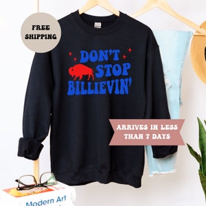 May include: Black sweatshirt with a red buffalo silhouette and blue text that reads "Don't Stop Billievin'".