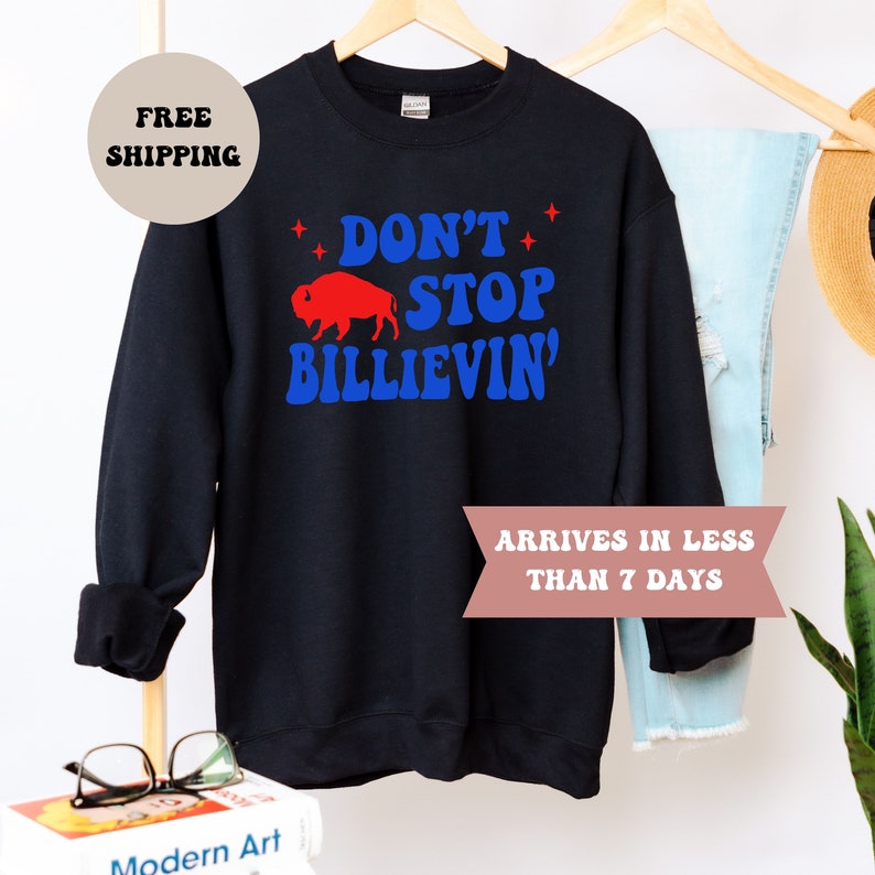 May include: Black sweatshirt with a red buffalo silhouette and blue text that reads "Don't Stop Billievin'".