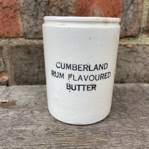 May include: White ceramic jar with black lettering that reads "CUMBERLAND RUM FLAVOURED BUTTER".