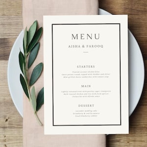 May include: A white menu card with black text and a black border. The menu is for Aisha & Farooq and lists the starters, main course, and dessert options.