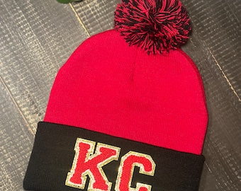 One of a kind red and blackPom beanie with red chenill letters KC