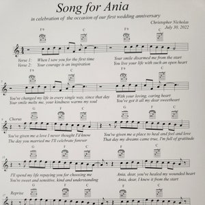 May include: A sheet of music with the title "Song for Ania" in celebration of a wedding anniversary. The music is written in standard notation with chords marked above the staff. The lyrics include phrases like "Your smile melts me" and "You've got it all my dear".
