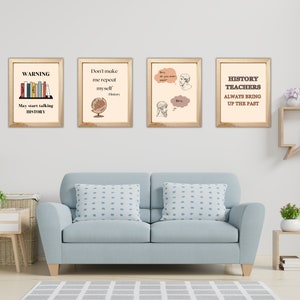 May include: Four framed art prints with history-themed quotes and illustrations. The prints are in wooden frames and hang above a light blue sofa. The quotes include "WARNING May start talking HISTORY", "Don't make me repeat myself History", "Bro, do you even read?" and "HISTORY TEACHERS ALWAYS BRING UP THE PAST".