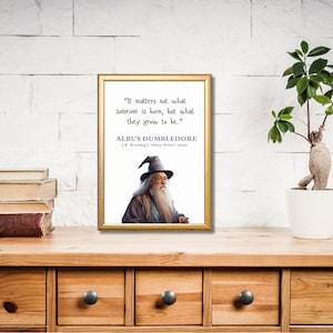 May include: A framed print with a quote by Albus Dumbledore from the Harry Potter series. The quote reads, "It matters not what someone is born, but what they grow to be." The print features an illustration of Albus Dumbledore in his signature wizard robes and hat.