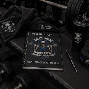 May include: A black spiral-bound training log book with a skull graphic and text reading YOUR NAME, DEAD INSIDE, REPS DON'T LIE, GAINS AREN'T GONNA GET THEMSELVES, and TRAINING LOG BOOK, accompanied by a black towel, shaker bottle, pen, and wrist wraps.