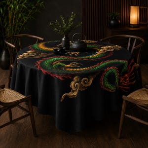 May include: A round black tablecloth featuring a large, detailed green and gold dragon illustration with red accents and stylized clouds. The dragon curves across the surface, which is topped with a black teapot and small bowls.