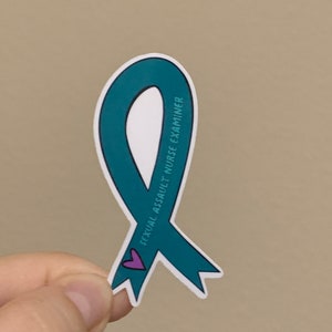 May include: Teal ribbon sticker with a small purple heart and the text "Sexual Assault Nurse Examiner".