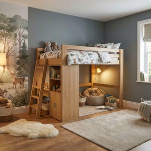 May include: A light wood loft bed with a built-in bookcase and storage cabinet. The bed has a ladder for access and is decorated with woodland-themed bedding and stuffed animals. A small reading nook is underneath the bed, with a beanbag chair and a lamp.