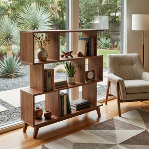 May include: A wooden bookcase in a mid-century modern style, featuring multiple shelves. The shelves are stocked with books, a small potted plant, a clock, and decorative items. The bookcase is positioned in front of a large window.