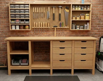 May include: A light wood workbench with drawers, shelves, and a pegboard for tools. The workbench has a natural wood finish and is set against a brick wall. Tools and supplies are organized for easy access.