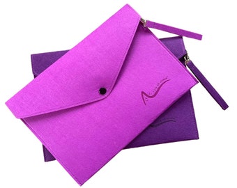 May include: Two felt envelope-style pouches in shades of purple. The top pouch is a vibrant lavender, with a flap secured by a black press stud. The bottom pouch is a deeper purple. Both have a zip and wrist strap. The text "...joy all around" is printed on the front.