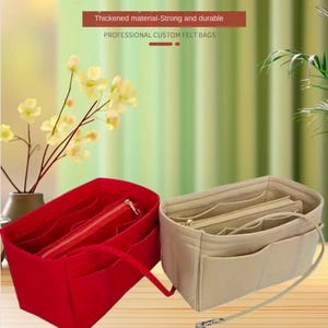 May include: Two felt cosmetic bags, one red and one beige, are displayed. The red bag has a zipper and handles. The beige bag has multiple compartments and a strap. Text at the top reads "Fashion Felt Cosmetic Bag".