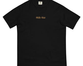 May include: Black t-shirt with the text "Made New" in a gold gothic font. The shirt is a solid black color and has a classic crew neck design. The shirt is made of a soft, comfortable material.