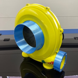 May include: A yellow inflatable blower with a blue air intake and a blue base. The blower has a cartoon graphic on the side.
