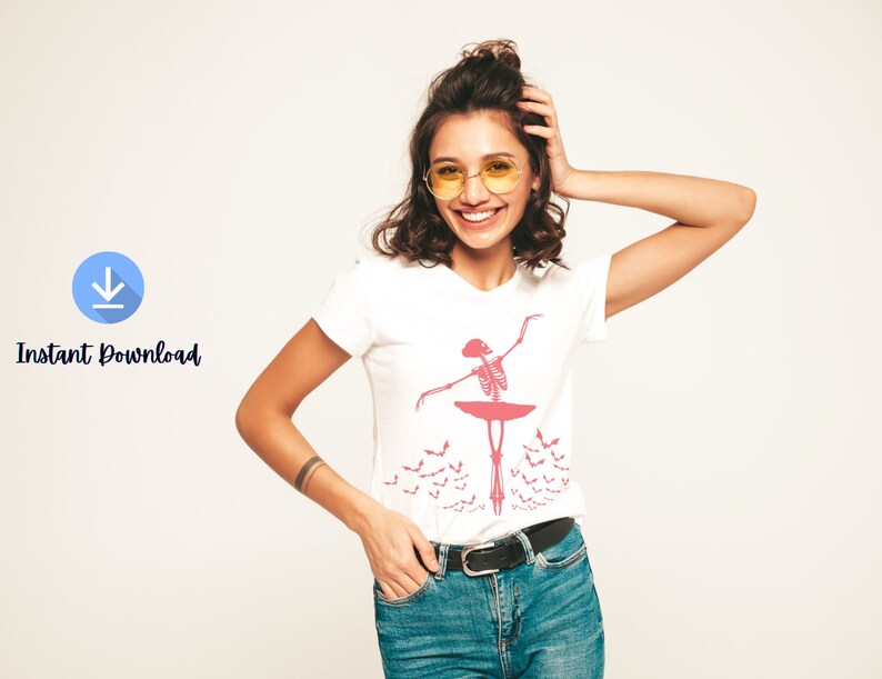 May include: White t-shirt featuring a pink skeleton ballerina design. The design includes a ballerina, a tutu, and bats. The words "Instant Download" are also visible.