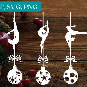 Può includere: Tre ornamenti in silhouette bianca di una persona che fa pole dance, ognuno con un design diverso sull'ornamento. Gli ornamenti sono appesi su uno sfondo di legno.