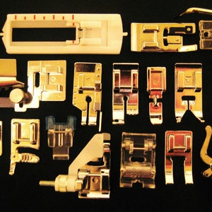 May include: A collection of sewing machine presser feet in various shapes and sizes. The feet are made of shiny metal and plastic, with a range of designs for different sewing tasks. The image is on a dark background.