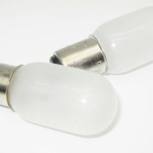 May include: Two frosted glass light bulbs with silver metal bases. The bulbs are small and oval shaped.