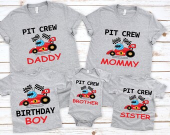 May include: A set of five gray t-shirts with a red race car graphic and the text "Pit Crew" on each shirt. The shirts have different text below the car, including "Daddy", "Mommy", "Birthday Boy", "Brother", and "Sister".