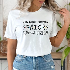 May include: White t-shirt with black text that reads "Our Final Chapter Seniors Season:20 Episode:25". The word "Seniors" is in colorful letters.
