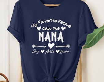 May include: Navy blue t-shirt with white text that reads "My favorite people call me Nana" with arrows and hearts. The names Amy, Ashlee, and Lauren are listed below.