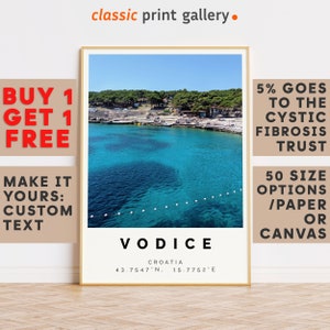 May include: Framed print featuring a vibrant turquoise seascape with the text "Vodice, Croatia" and coordinates. The print includes the text "Buy 1 Get 1 Free" and "Make it Yours: Custom Text". The print is from the "classic print gallery".