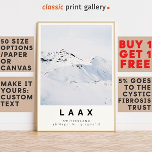 May include: A framed print featuring a snow-covered mountain landscape. The print includes the text "LAAX SWITZERLAND" with coordinates. Additional text on the frame indicates "50 SIZE OPTIONS /PAPER OR CANVAS" and "MAKE IT YOURS: CUSTOM TEXT". The top of the frame reads "classic print gallery."