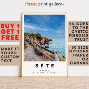 May include: A framed print showing a coastal scene with a path and wooden fence, the sea, and a blue sky. The print has the text "Sète, France" and coordinates. The words "classic print gallery" are at the top.