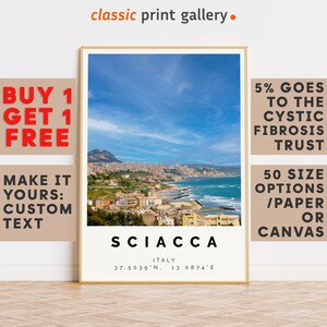 May include: A framed print of Sciacca, Italy, featuring a coastal town under a blue sky with clouds. The print includes the town's name, coordinates, and the text "classic print gallery."